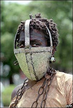 black slave wearing a metal mask covering mouth and nose